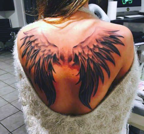 woman wings on back tattoo