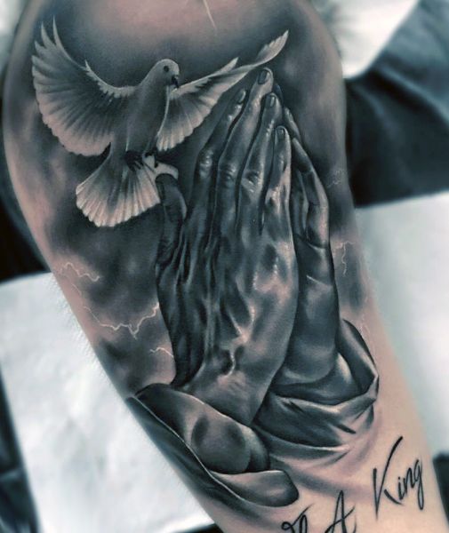 praying hands and dove tattoo