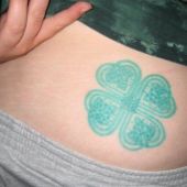 lower back tattoo four-leaf clover