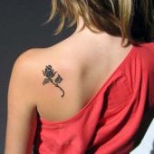 small rose tattoo on shoulder