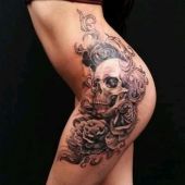 skull and roses hip tattoo