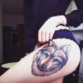 tatuaże damskie wilk na udzie