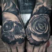 rose and skull tattoo on hands
