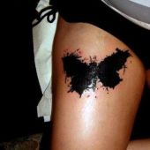black butterfly tattoo on thigh