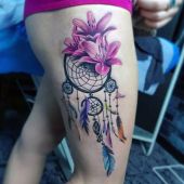 dreamcatcher and lily thigh tattoo