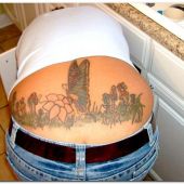 lower back tattoo motyl na trawie