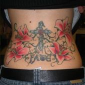 lower back tattoo cross flowers