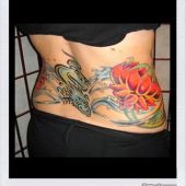 lower back tattoos dragon flowers