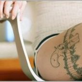 girl gun thigh tattoo