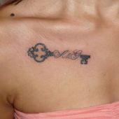 key woman chest tattoo